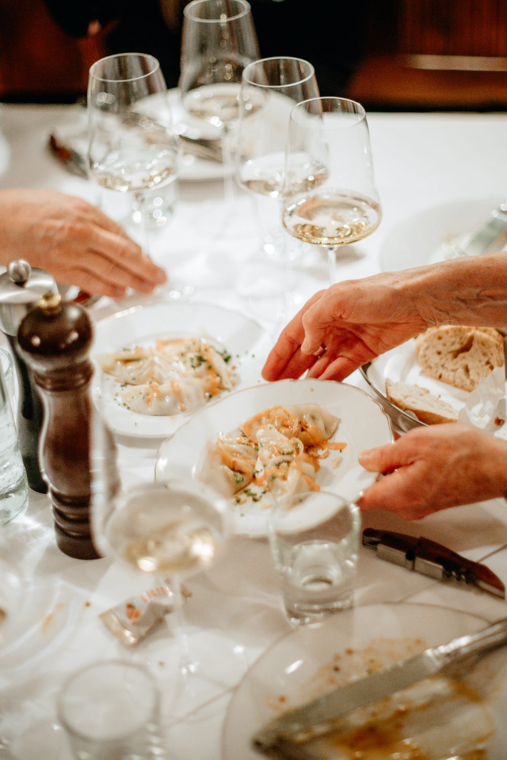Pouring white wine under warm lights